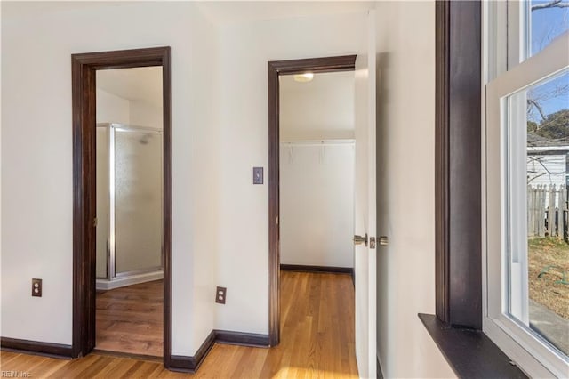 hallway with light hardwood / wood-style floors