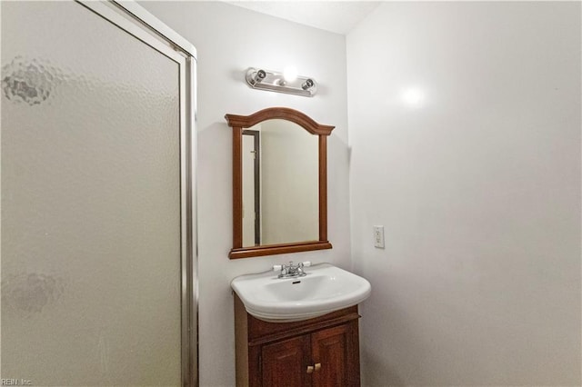 bathroom with walk in shower and vanity