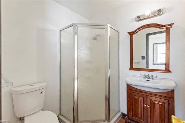 bathroom with toilet, a shower with shower door, and vanity