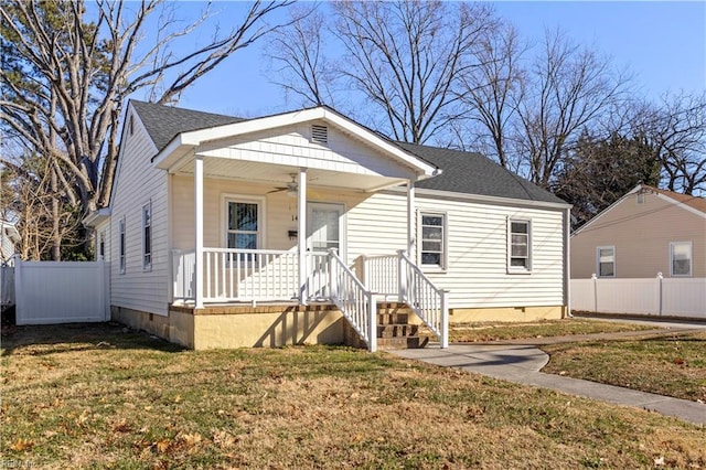 bungalow-style house with ceiling fan, a porch, and a front lawn