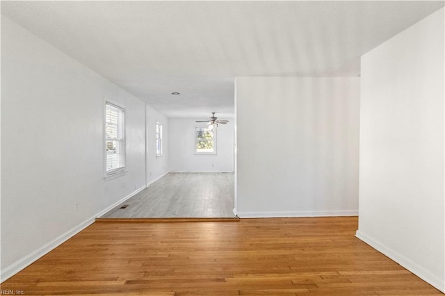 unfurnished room featuring light wood-type flooring and ceiling fan