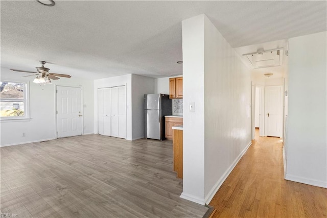 interior space featuring ceiling fan and light hardwood / wood-style flooring