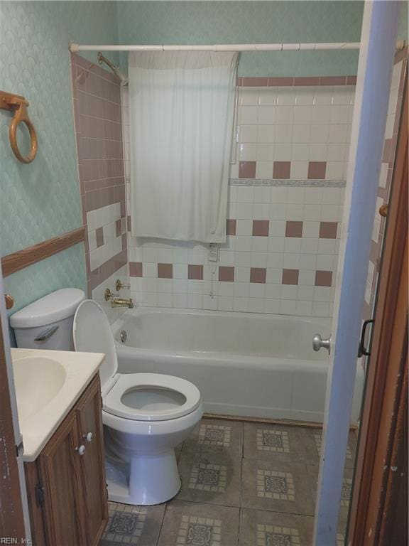 full bathroom featuring toilet, vanity, and tiled shower / bath