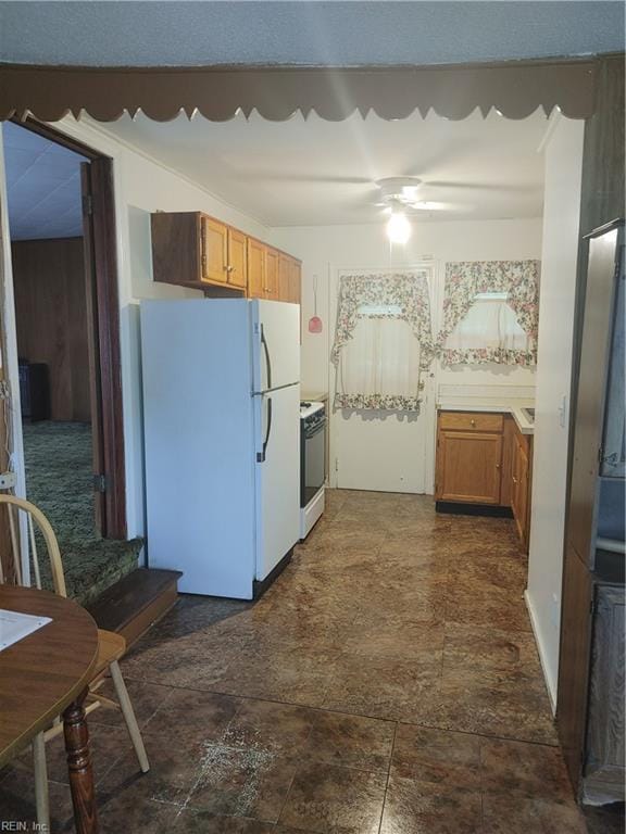 kitchen featuring white appliances and ceiling fan