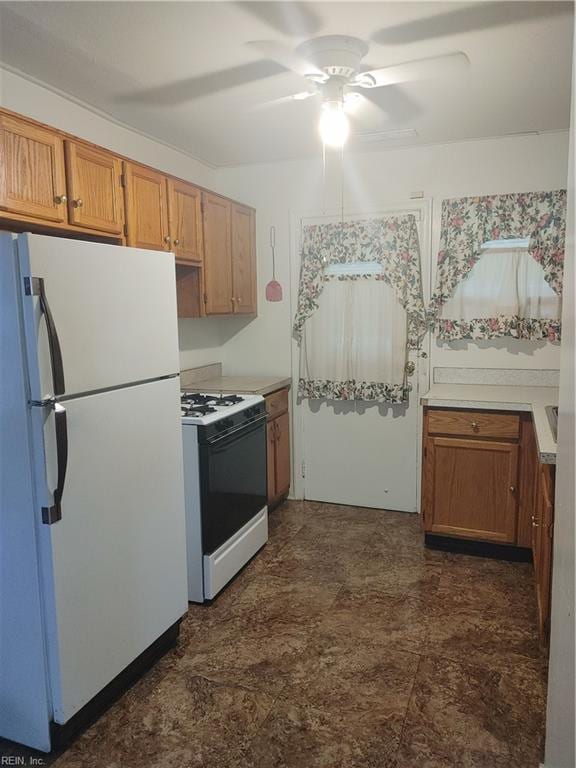 kitchen featuring white appliances and ceiling fan