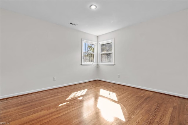 empty room with wood-type flooring