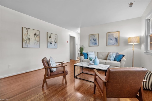 living room featuring light wood-type flooring and radiator heating unit