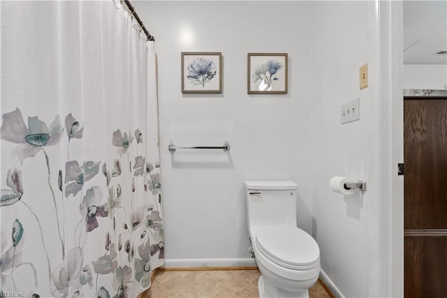 bathroom with toilet and curtained shower