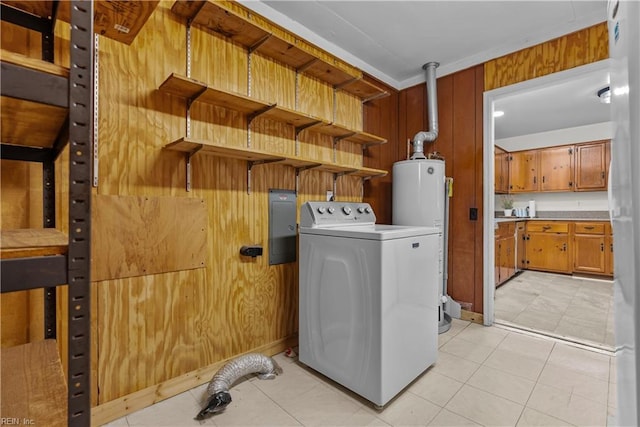 clothes washing area with washer / dryer, water heater, wooden walls, and light tile patterned floors