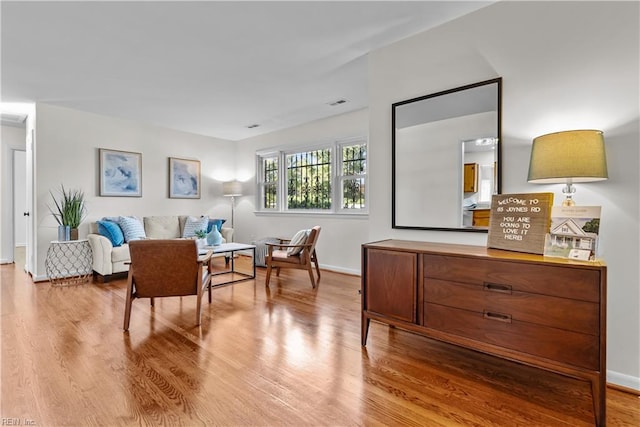 sitting room with hardwood / wood-style flooring