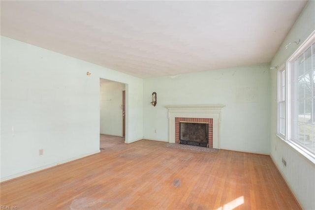 unfurnished living room with light hardwood / wood-style flooring and a fireplace