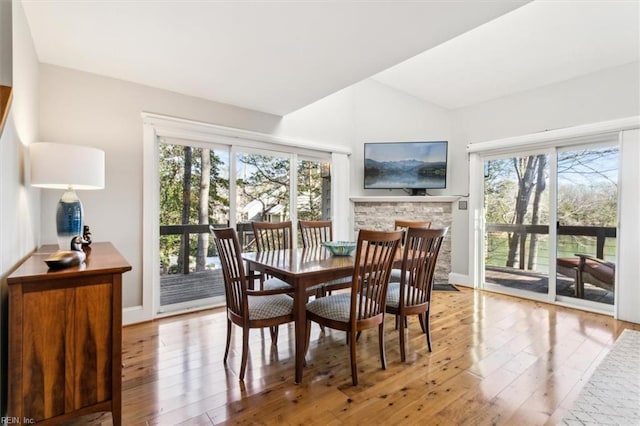 dining room featuring light hardwood / wood-style flooring and a fireplace