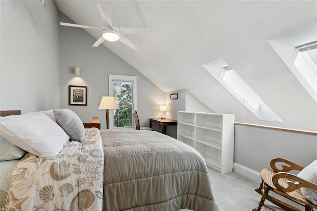 carpeted bedroom with ceiling fan and vaulted ceiling with skylight