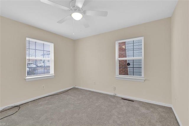 carpeted empty room featuring ceiling fan