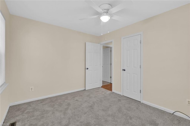 unfurnished bedroom featuring ceiling fan and light carpet