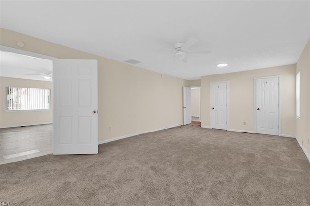 unfurnished room featuring ceiling fan and carpet