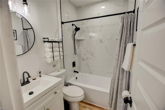 full bathroom featuring toilet, vanity, wood-type flooring, and shower / bathtub combination with curtain