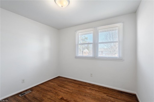 empty room featuring dark hardwood / wood-style flooring