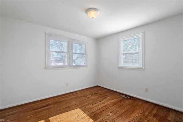 spare room featuring wood-type flooring