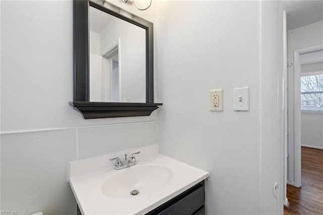 bathroom with vanity and hardwood / wood-style flooring