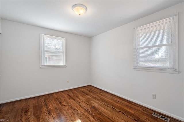 spare room with dark wood-type flooring