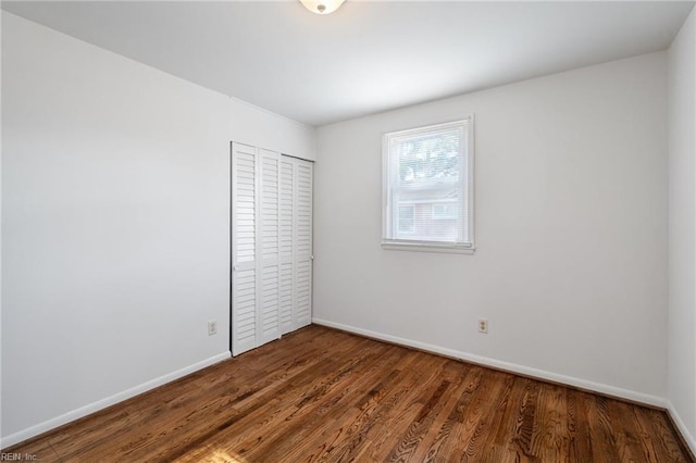 unfurnished bedroom with a closet and hardwood / wood-style floors