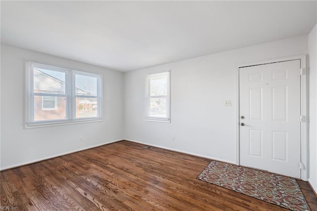 spare room with dark wood-type flooring