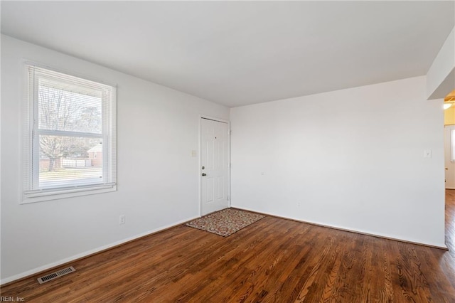 unfurnished room with wood-type flooring