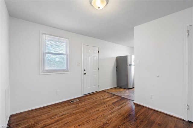 unfurnished room featuring dark wood-type flooring