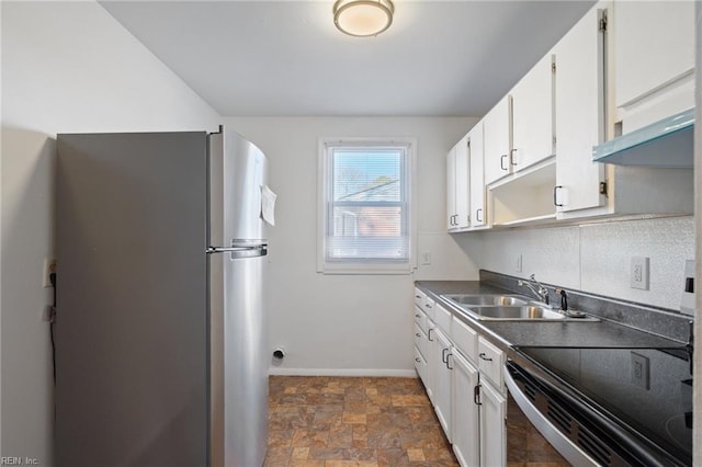 kitchen with sink, white cabinetry, and stainless steel fridge