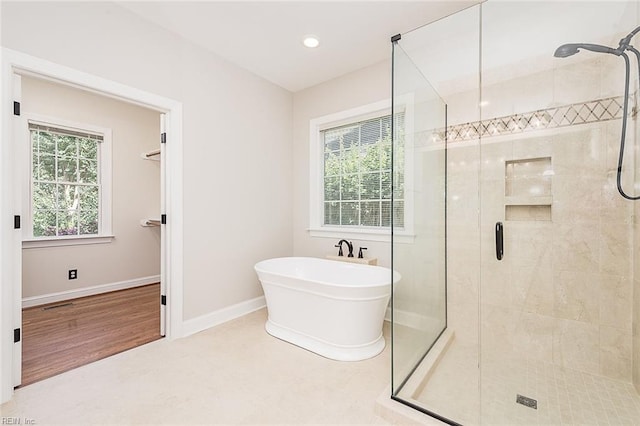 bathroom with plenty of natural light and plus walk in shower