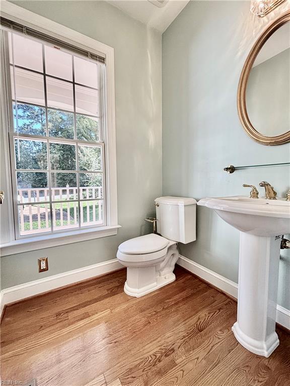 bathroom featuring toilet and wood-type flooring