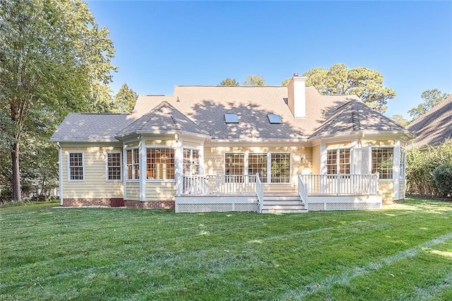 back of house with a lawn and a deck