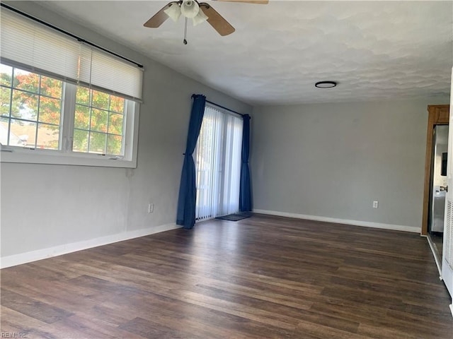 spare room with ceiling fan and dark hardwood / wood-style floors