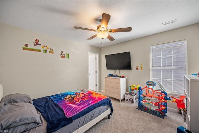 bedroom featuring light carpet and ceiling fan