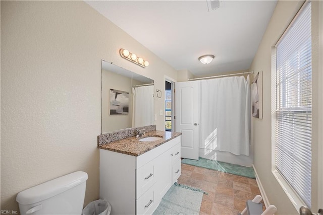 bathroom featuring toilet and vanity