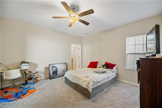 bedroom with ceiling fan and light carpet