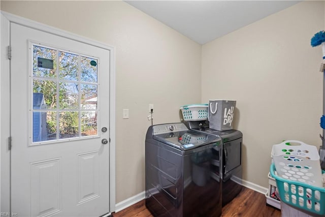 laundry area featuring washer and dryer and dark wood-type flooring