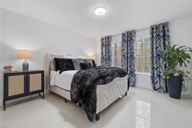 tiled bedroom with a textured ceiling