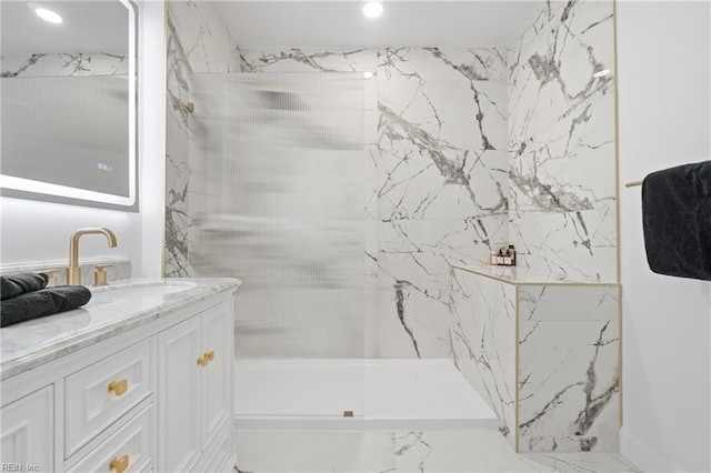 bathroom featuring vanity and tiled shower