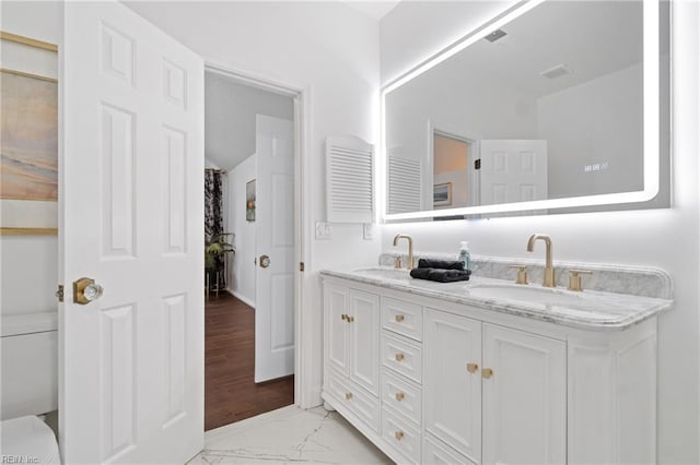 bathroom featuring toilet and vanity