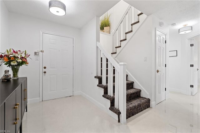 foyer featuring a textured ceiling