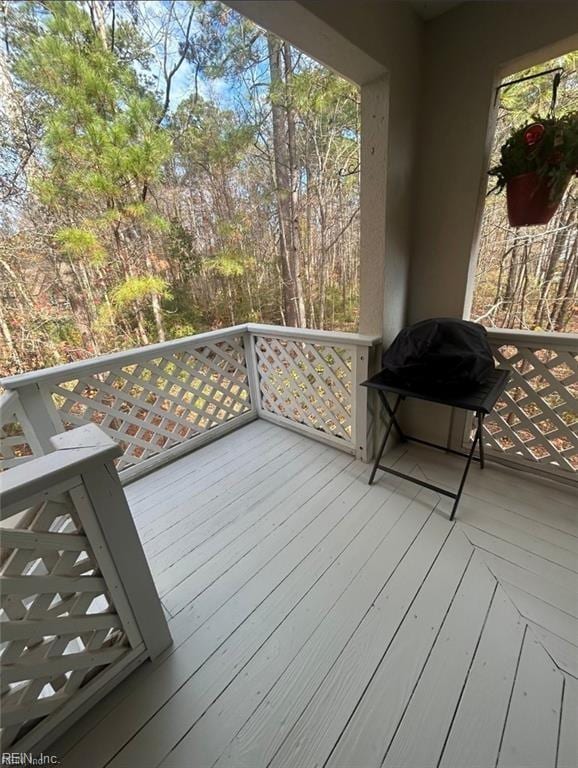 wooden deck featuring a grill