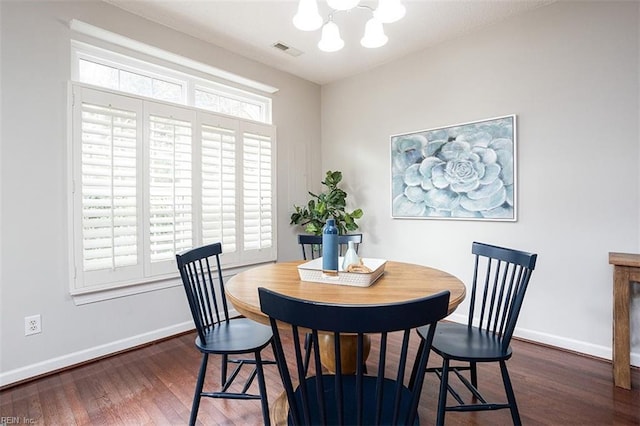 dining room with a chandelier, plenty of natural light, and dark hardwood / wood-style floors