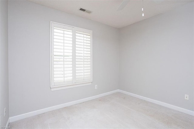 carpeted spare room with ceiling fan