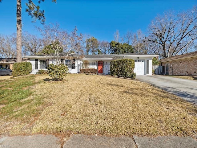 single story home featuring a front lawn and a garage