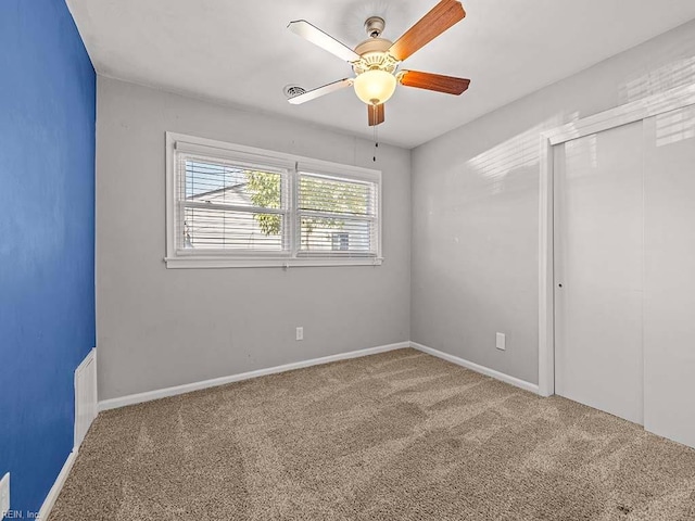 unfurnished bedroom with carpet floors, a closet, and ceiling fan