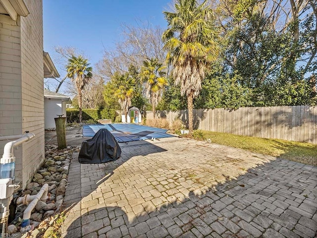 view of patio featuring a shed