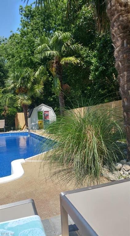 view of pool with a storage unit