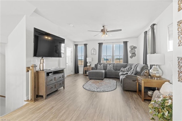 living room with ceiling fan and light hardwood / wood-style floors